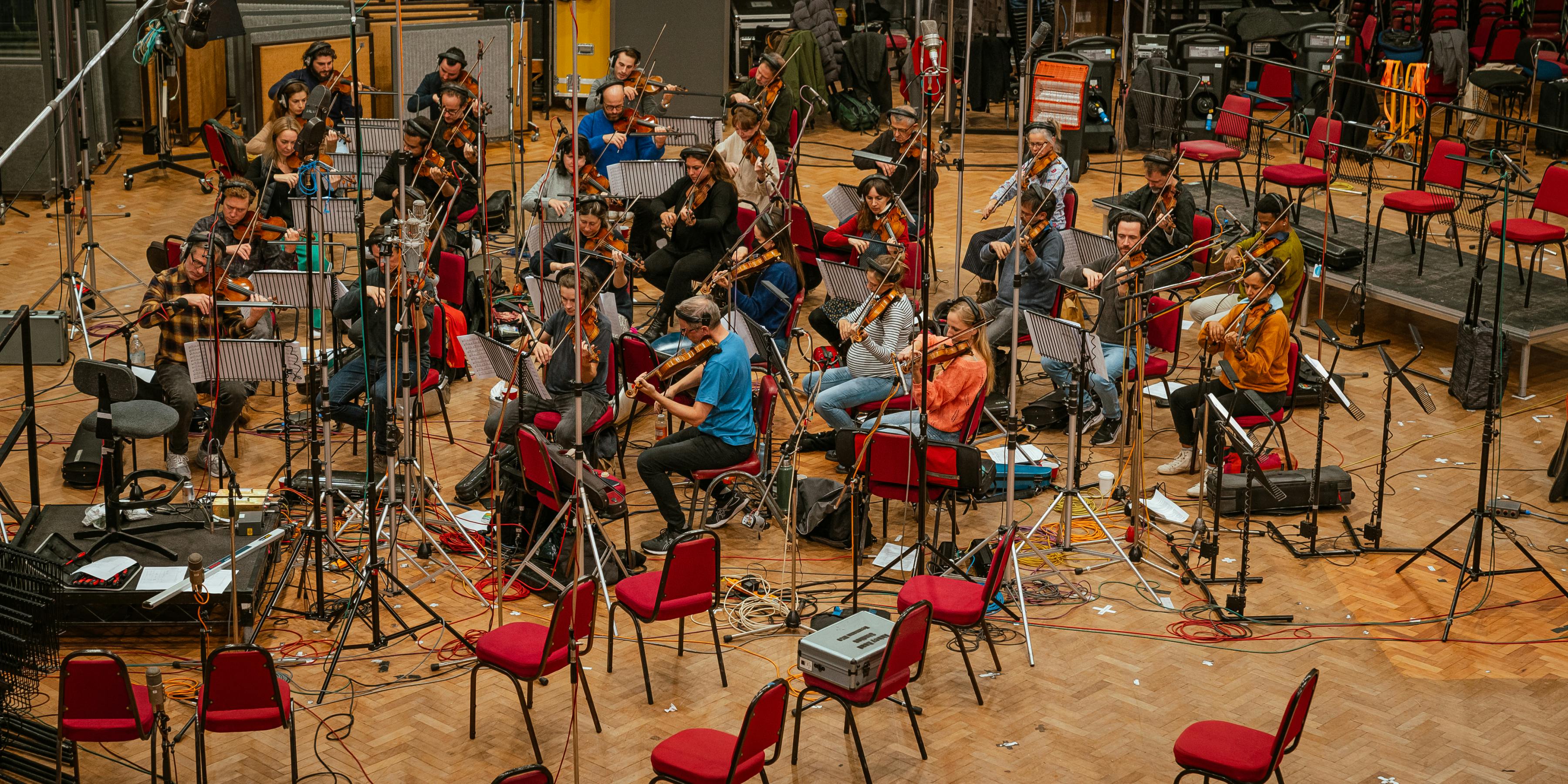 Overhead view of violinists performing in Abbey Road Studios