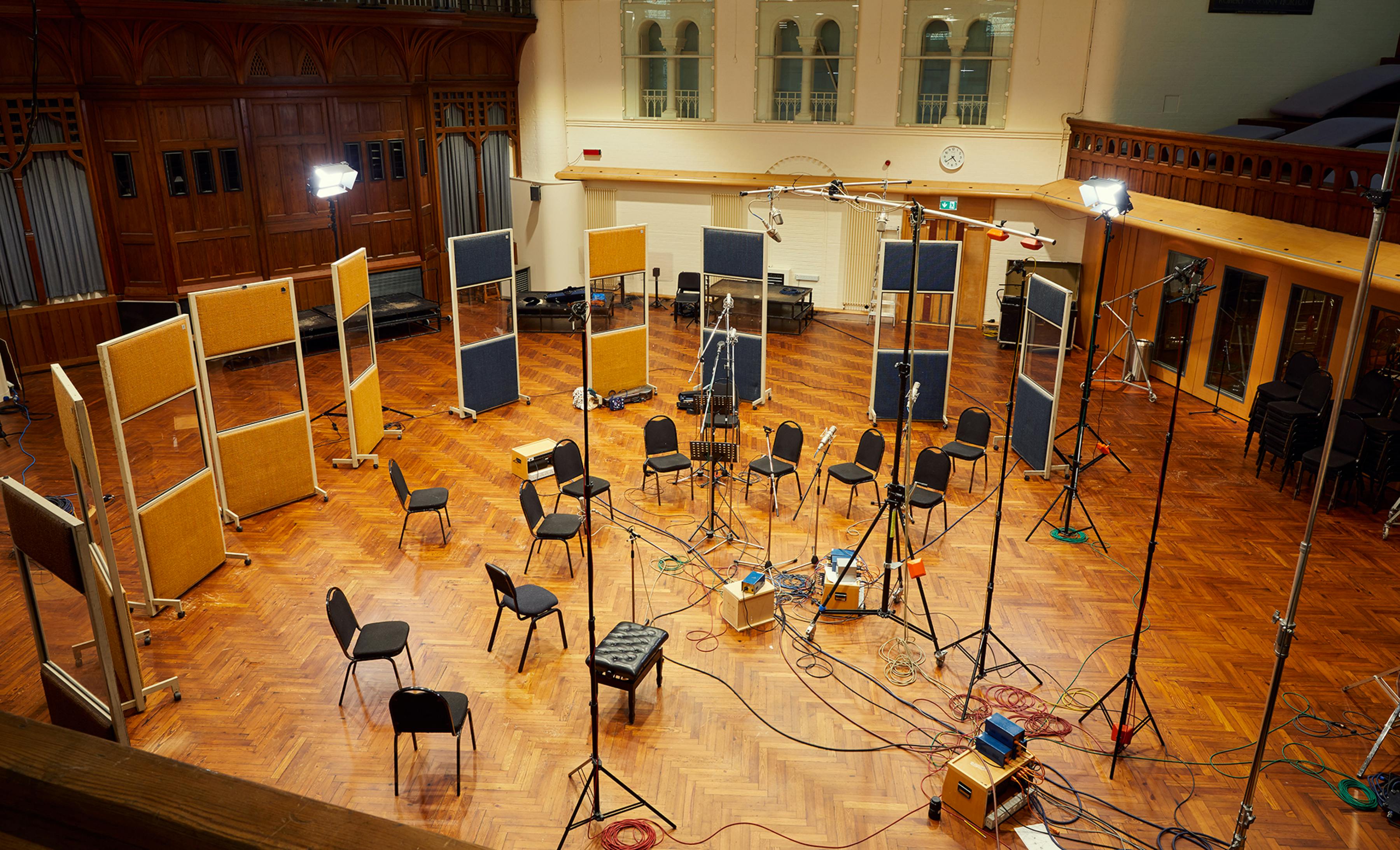 Empty chairs and microphones set up in AIR Studios, surrounded by sound panels