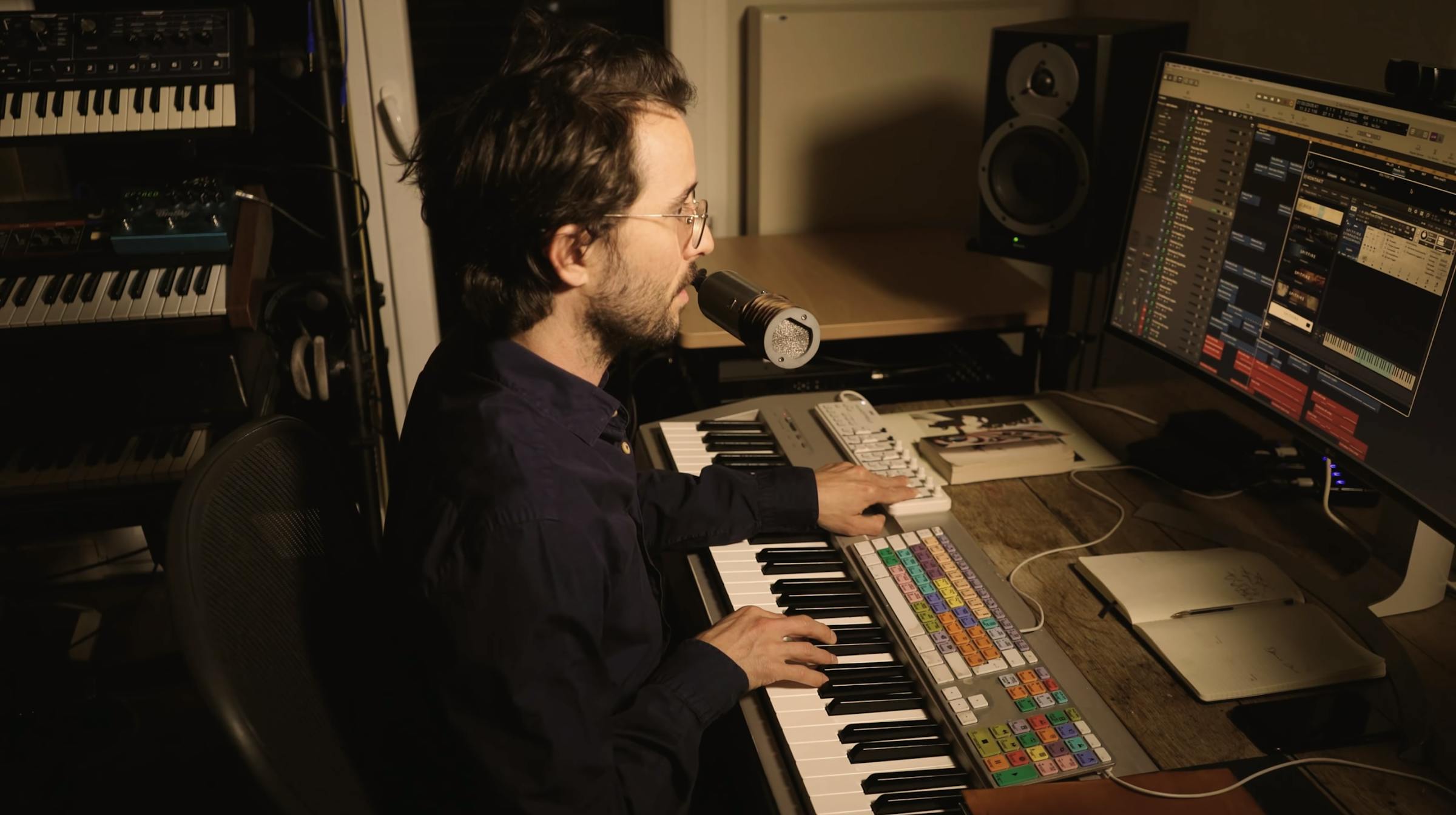Oliver at his studio desk playing a MIDI keyboard