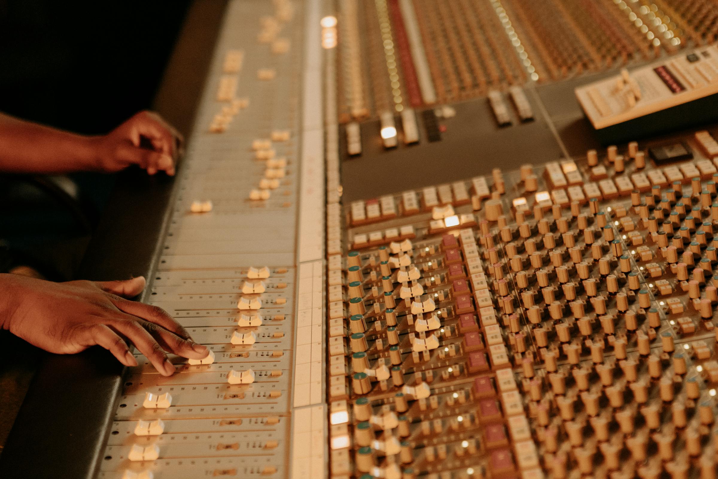 Man moving faders on a mix desk