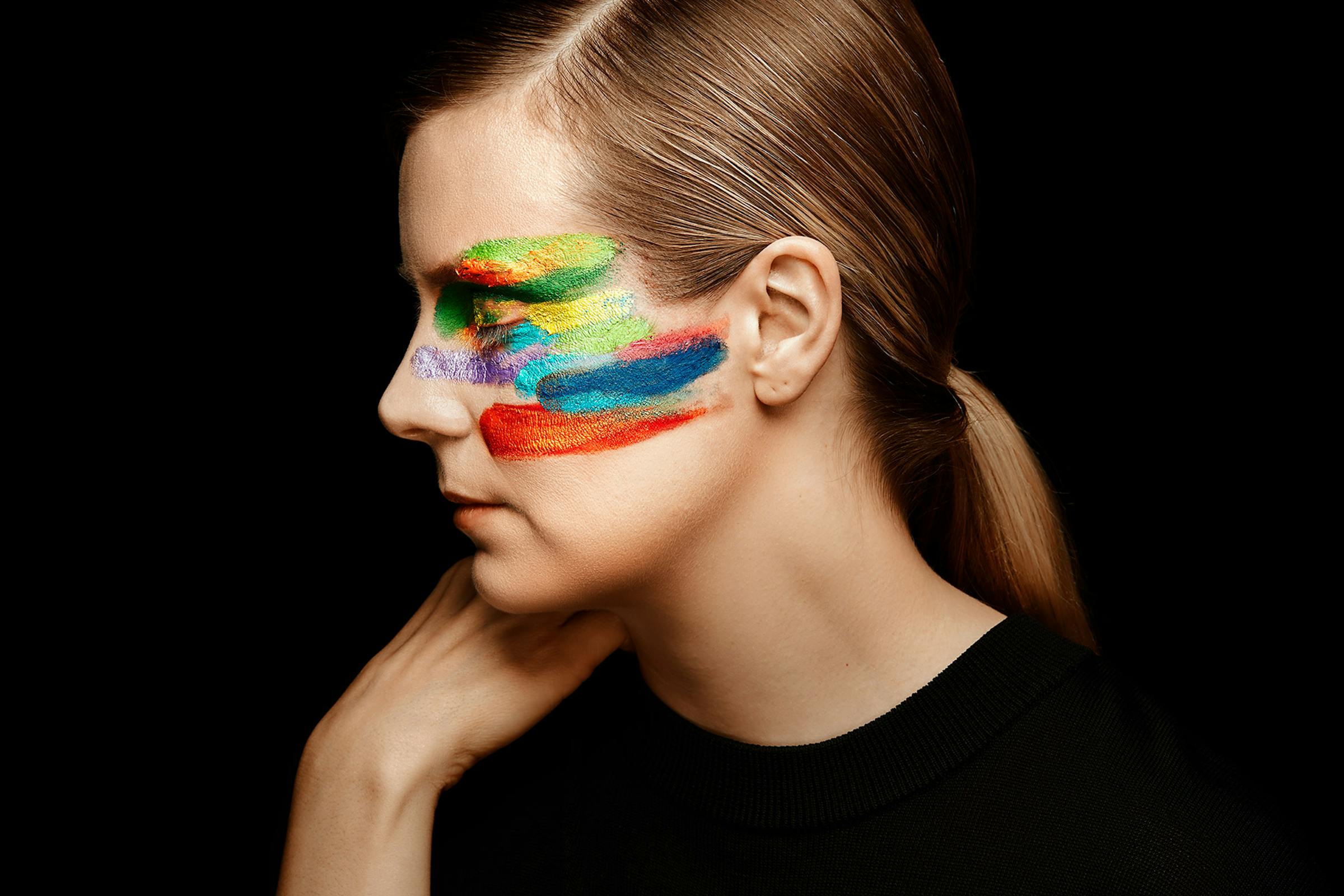 Woman looking to the side with painted face,  close up