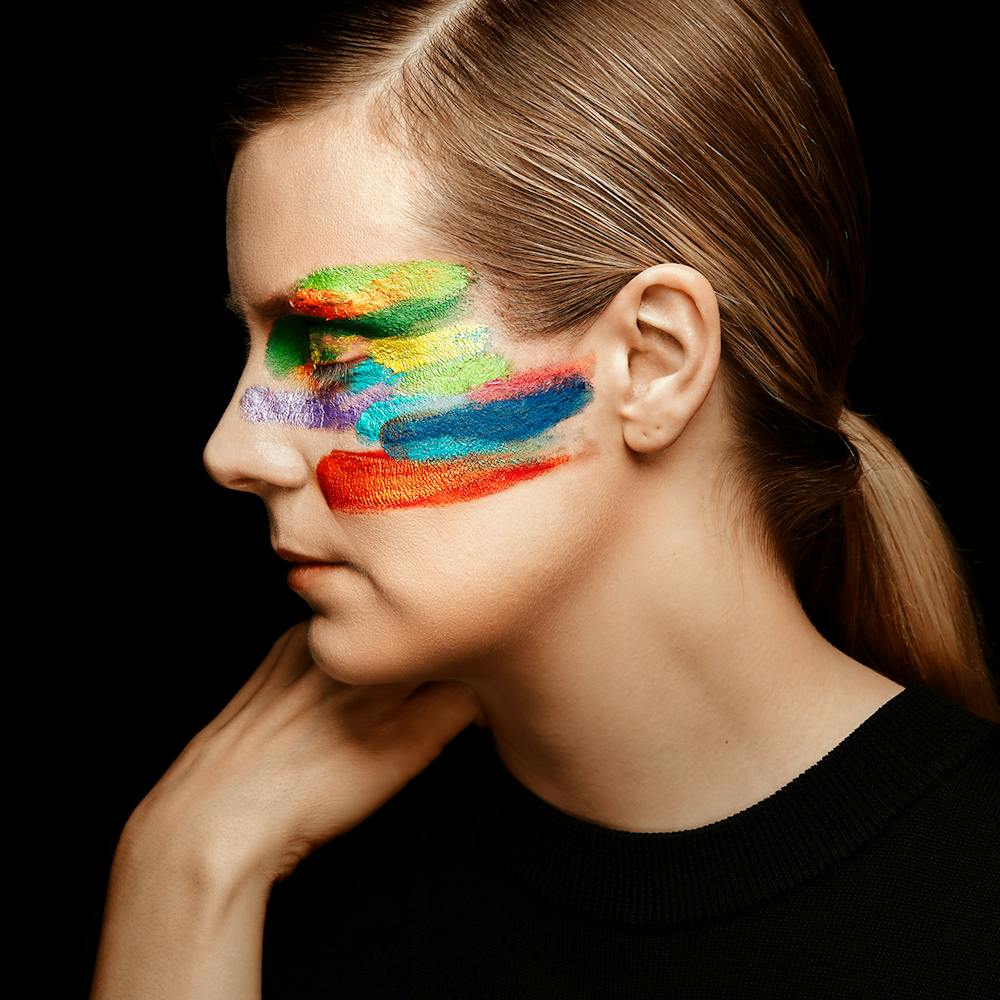 Woman looking to the side with painted face,  close up
