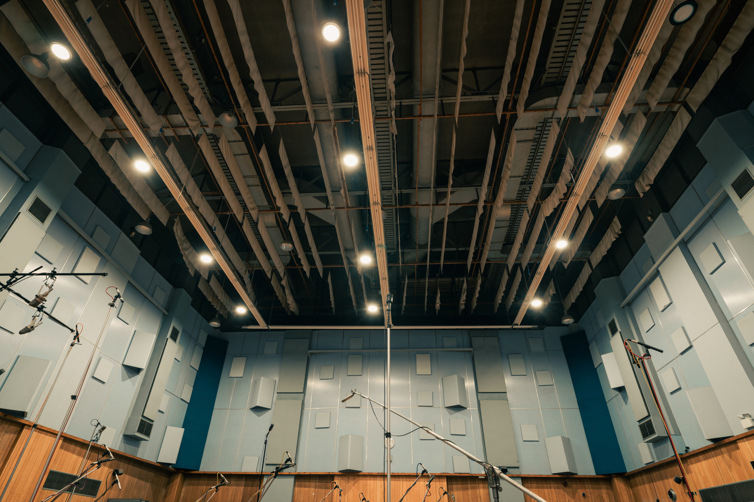 Wide shot of Abbey Road Studios' microphones extending out in front of the walls and ceiling.