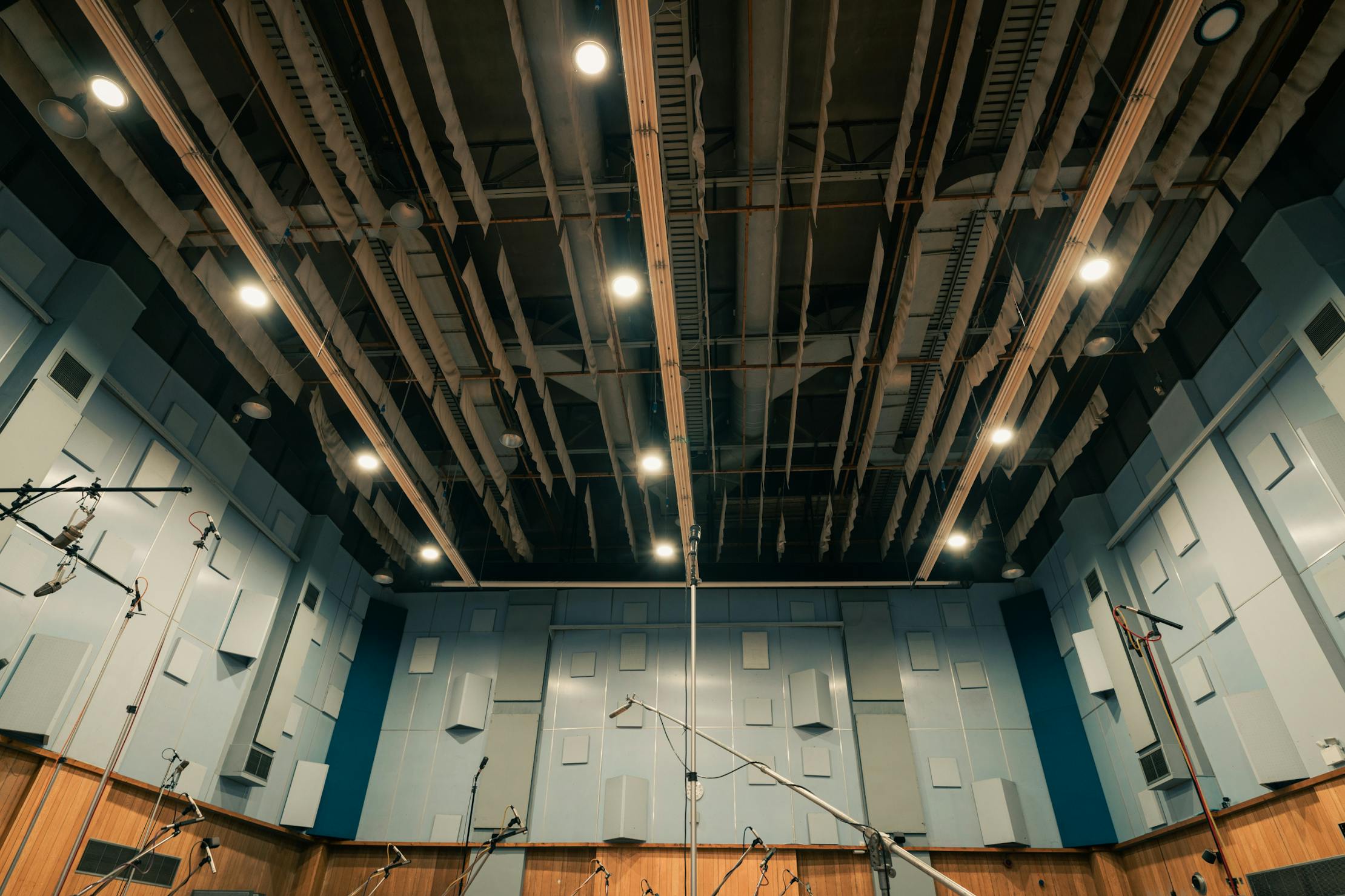 Wide shot of Abbey Road Studios' microphones extending out in front of the walls and ceiling.
